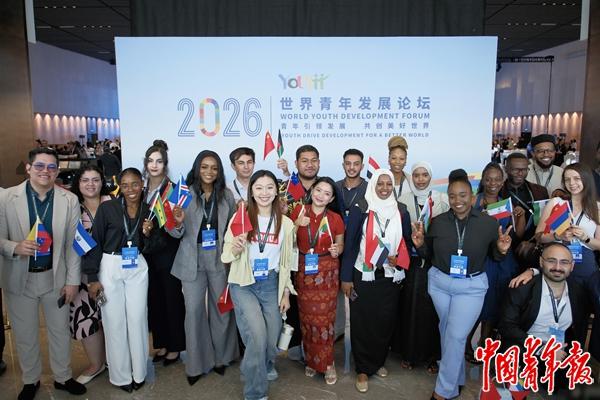 　　6月15日，湖北武汉，2026年世界青年发展论坛开幕式会场外，来自各国的青年代表手举各国国旗合影留念。中青报·中青网记者 田嘉硕/摄