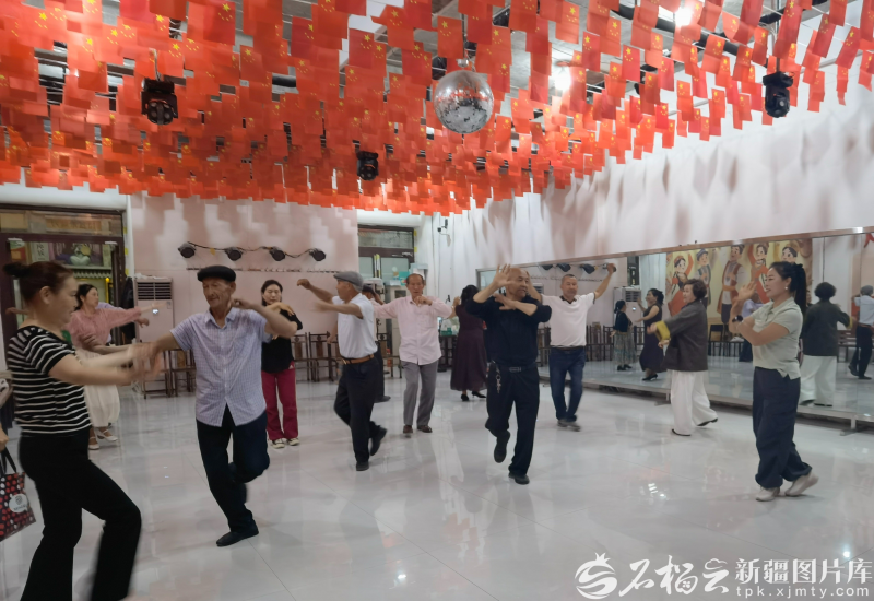 5月21日，在新和县新沙路商业街，石榴花开麦舞队和游客互动。石榴云/新疆日报记者 陈疆林摄