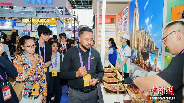 9月17日，广西南宁，观众在第23届中国—东盟博览会“广西国际友城进东博”展区了解西班牙特色美食。李蓉荣 摄
